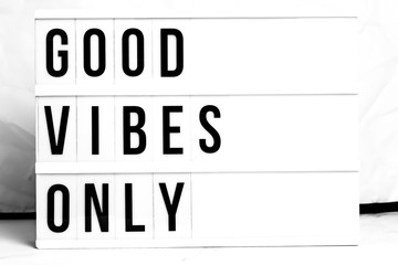 Inspirational Good Vibes Only quote on vintage retro board. Concept. flat lay