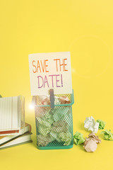Handwriting text writing Save The Date. Conceptual photo remember not schedule anything else on this day Trash bin crumpled paper clothespin empty reminder office supplies yellow