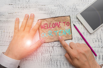 Handwriting text writing Welcome To Our Team. Conceptual photo introducing another demonstrating to your team mates Hand hold note paper near writing equipment and modern smartphone device