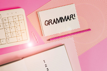 Writing note showing Grammar. Business concept for whole system structure language syntax and morphology Writing equipments and computer stuffs placed above colored plain table