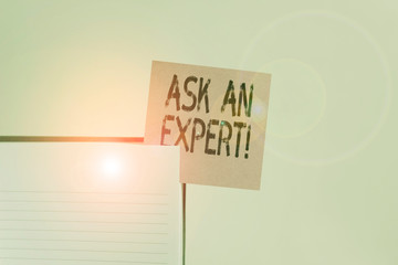 Text sign showing Ask An Expert. Business photo showcasing confirmation that have read understand and agree with guidelines Upper view lined hard cover note book sticky note inserted clear background