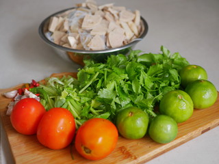 Vegetables on a wooden cutting board for making spicy glass noodle and Vietnamese pork sausage salad, Yam Woon Sen Moo Yaw