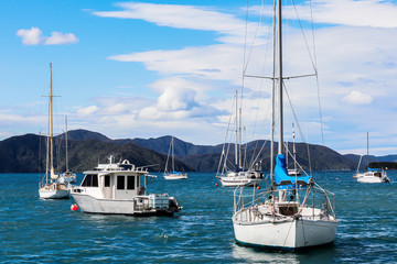 boat in blue sea water cloudy sky and mountain range