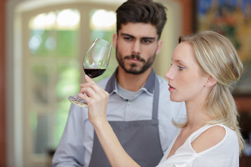 a woman is wine tasting