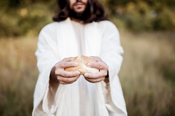 Biblical scene - of Jesus Christ splitting the bread with a blurred background