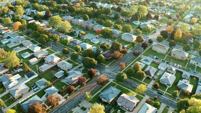 Aerial view of residential houses at autumn (october). American neighborhood, suburb. Real estate, drone shots, sunset, sunny morning,  sunlight, from above