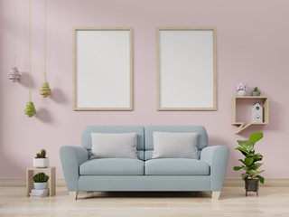 Interior poster mockup with vertical empty wooden frame standing on wooden floor with sofa on pink background.