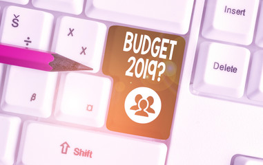 Handwriting text writing Budget 2019 Question. Conceptual photo estimate of income and expenditure for next year White pc keyboard with empty note paper above white background key copy space