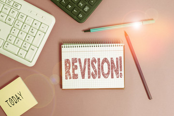 Writing note showing Revision. Business concept for action of revising over someone like auditing or accounting Writing equipments and computer stuff placed on wooden table