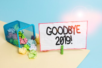 Conceptual hand writing showing Good Bye 2019. Concept meaning express good wishes when parting or at the end of last year Trash bin crumpled paper clothespin reminder office supplies