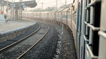 Indian railway train,at station platform,view from window at dawn,Tamil Nadu,India.