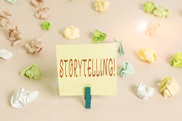 Writing note showing Storytelling. Business concept for activity writing stories for publishing them to public Colored crumpled papers empty reminder pink floor background clothespin