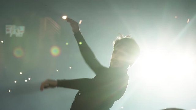 Close up man dancer on the night scene white light at live concert performance stage artist celebration dance disco young event festival fun nightlife party show blur dancing dark emotion slow motion