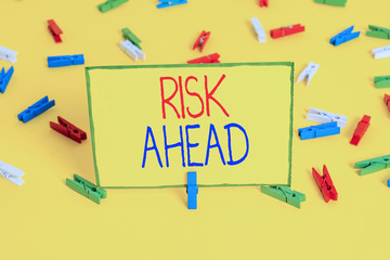 Word writing text Risk Ahead. Business photo showcasing A probability or threat of damage, injury, liability, loss Colored clothespin papers empty reminder yellow floor background office