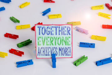 Word writing text Together Everyone Achieves More. Business photo showcasing Members create synergy with strong sense mutual commitment Colored clothespin papers empty reminder white floor background