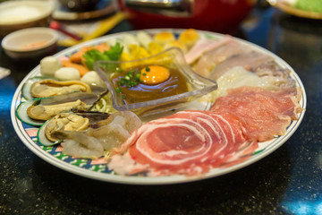Sukiyaki Japanese food shabu shabu. Sukiyaki Fresh Beef pork slices, Vegetable, Dinner Set. shabu or suki yaki set in metal trey placed on table.