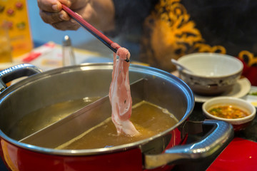Fototapeta na wymiar Meat and vegetable in sukiyaki pot boiled and steam, choose boiled food for healthy and avoid fried food and grilled food is concept. Selective focus Shabu Shabu and Sukiyaki, Japanese food