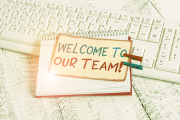 Writing note showing Welcome To Our Team. Business concept for introducing another demonstrating to your team mates notebook reminder clothespin with pinned sheet light wooden