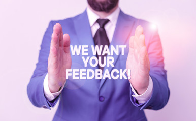 Word writing text We Want Your Feedback. Business photo showcasing criticism given someone say can be done for improvement Man with opened hands in fron of the table. Mobile phone and notes on the