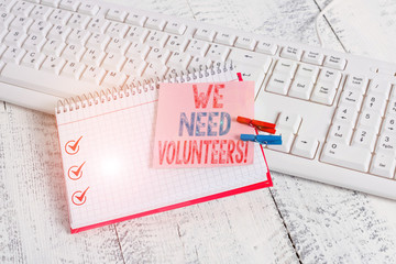 Writing note showing We Need Volunteers. Business concept for someone who does work without being paid for it notebook reminder clothespin with pinned sheet light wooden