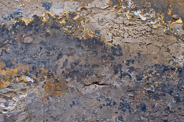 Beautiful old decaying wall with weathered mosaic of old paint and plaster.