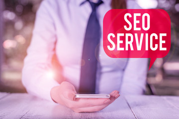 Writing note showing Seo Service. Business concept for techniques and procedures to increase the...