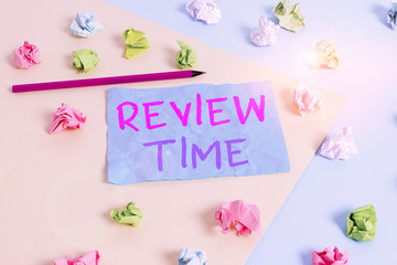 Conceptual hand writing showing Review Time. Concept meaning to think or talk about something again Set schedule to review Colored crumpled paper empty reminder blue yellow clothespin