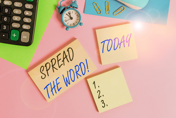 Text sign showing Spread The Word. Business photo showcasing share the information or news using social media Wire mouse portable calculator notepads paper sheets clips color background