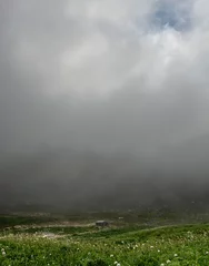 Fotobehang Thick Fog Over Alpine Field and Historic Building © kellyvandellen