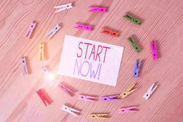 Text sign showing Start Now. Business photo text do not hesitate get working or doing stuff right away Colored clothespin papers empty reminder wooden floor background office