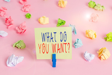 Writing note showing What Do You Want Question. Business concept for say or write in order to ask demonstrating about something Colored crumpled papers empty reminder pink floor background clothespin