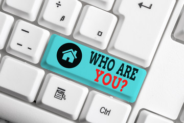 Text sign showing Who Are You Question. Business photo text asking about someone identity or demonstratingal information White pc keyboard with empty note paper above white background key copy space