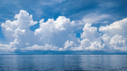 blue sky with clouds reflected in water
