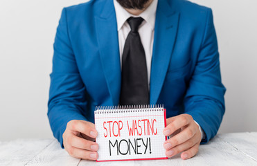 Writing note showing Stop Wasting Money. Business concept for advicing demonstrating or group to...