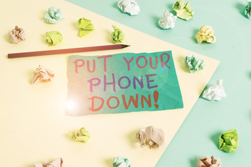Fototapeta na wymiar Conceptual hand writing showing Put Your Phone Down. Concept meaning end telephone connection saying goodbye caller Colored crumpled paper empty reminder blue yellow clothespin