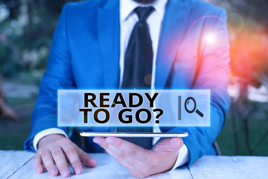 Handwriting text Ready To Go Question. Conceptual photo asking someone if he is prepared or packed his things Businessman with mobile phone in his hand