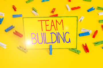 Word writing text Team Building. Business photo showcasing various types of activities used to enhance social relations Colored clothespin papers empty reminder yellow floor background office