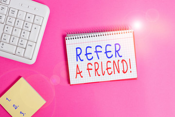 Text sign showing Refer A Friend. Business photo showcasing direct someone to another or send him something like gift Writing equipments and computer stuffs placed above classic wooden table