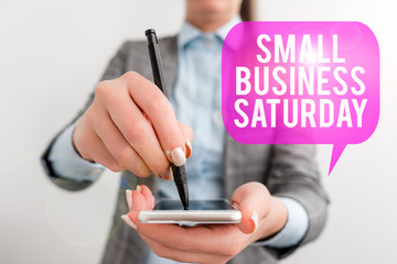 Word writing text Small Business Saturday. Business photo showcasing American shopping holiday held during the Saturday Business woman pointing in empty space with pen