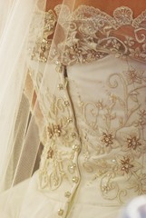  Close up of an intricate lace design at the back of a wedding dress