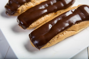 High angle view of Chocolate eclair, filled with fresh whipped cream and topped with chocolate...