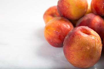 Front view of healthy red and yellow peaches on white background with copy area