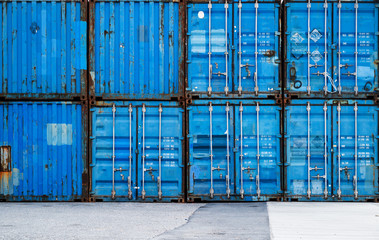 ,Stack of blue containers in a harbour for background.blue cargo containers in port