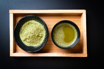 hot matcha green tea cup with green tea powder and whisk