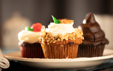 cupcakes with frosting, nuts and sprinkles