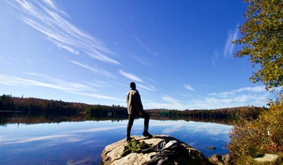 Powerful man standing on a rock 