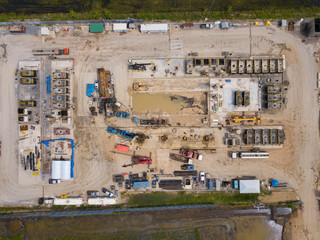 Oil and gas a land rig, onshore drilling rig, in the middle of a rice field aerial view from a...