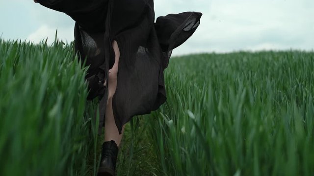 Girl In Black Dress Runs The Field. Romantic Image Of Blonde.