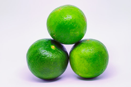 3 Round Kiefer / Key Limes Stacked In A Pyramid Isolated On A White Background.