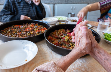 Old woman enjoying some homemade okra